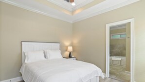 A bedroom with a bed, nightstand, and lamp. - Charming 3-bedroom house located minutes from LSU (Baton Rouge)