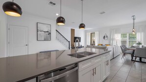 A modern kitchen with a central island, stainless steel appliances, and pendant lighting. - SL4359 - 5BR house with private pool in Kissimmee (Kissimmee)