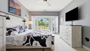 A bedroom with a bed, a dresser, a television, and a ceiling fan. - NEWLY RENOVATED 2BR Golfer's Paradise Condo at World Tour (Myrtle Beach)