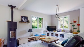 A living room with a fireplace, a television, a sofa, and a coffee table.