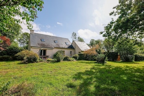 A house with a sloped roof, a front door, and a small porch.