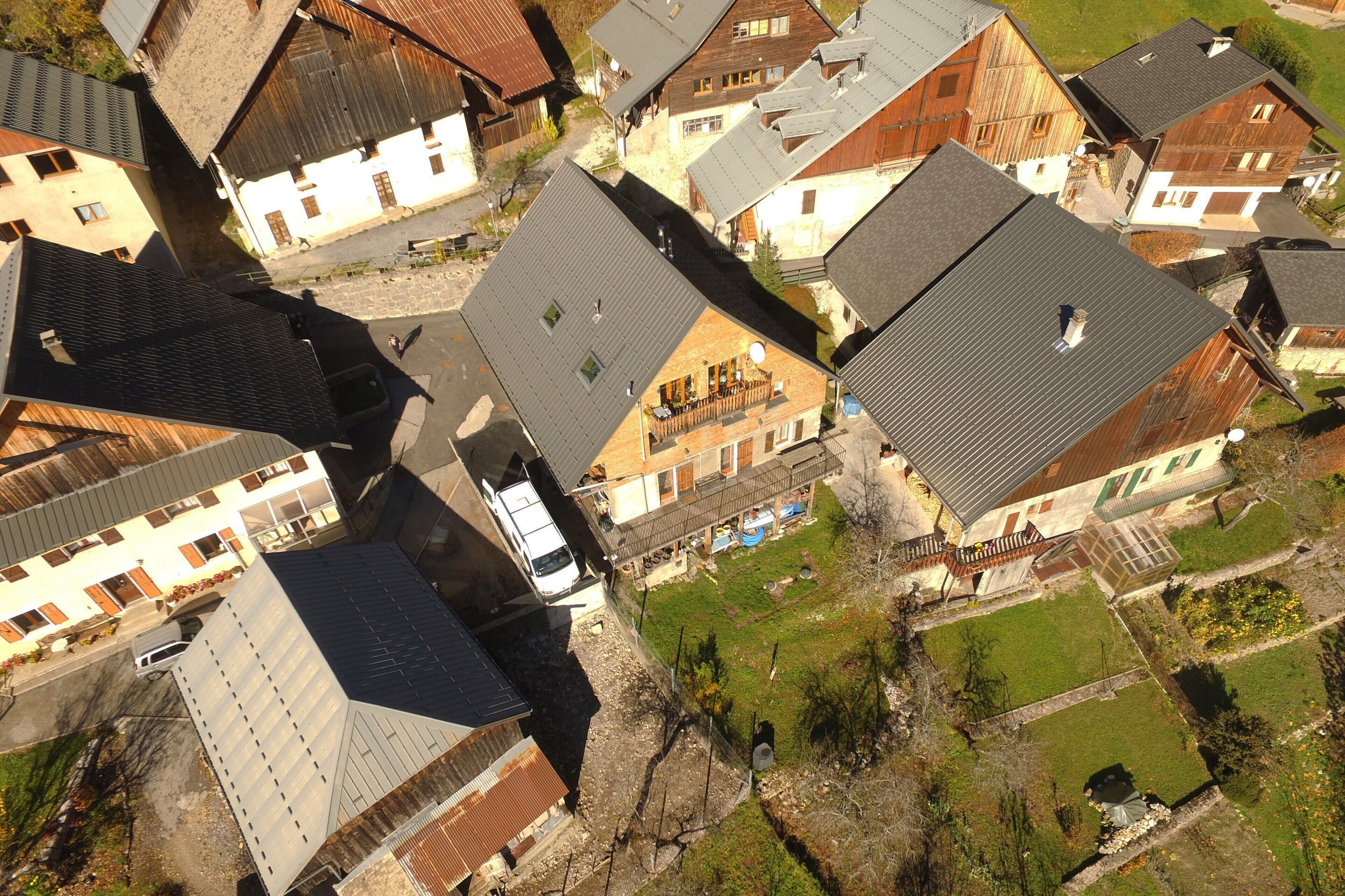 A residential area with multiple houses, some with sloped roofs and others with flat roofs.