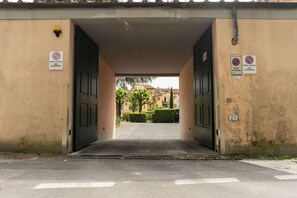 A building entrance with two doors, a no parking sign, and a no stopping sign.