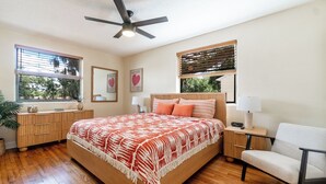 A bedroom with a wooden bed, a nightstand, a chair, a ceiling fan, and a window with blinds. - Remodeled unit steps from San Marco cafes and shops and near Riverwalk (Jacksonville)