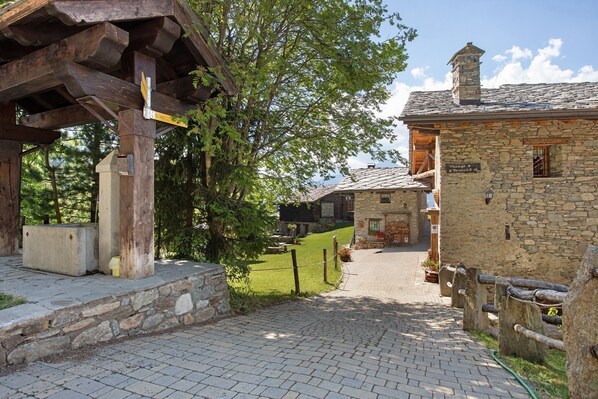 A stone building with a sign reading 'Village & Pizzeria.'