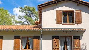 A two-story building with a tiled roof, wooden shutters, and a white facade. - Les 2 plages by Interhome (Vaux Sur Mer)