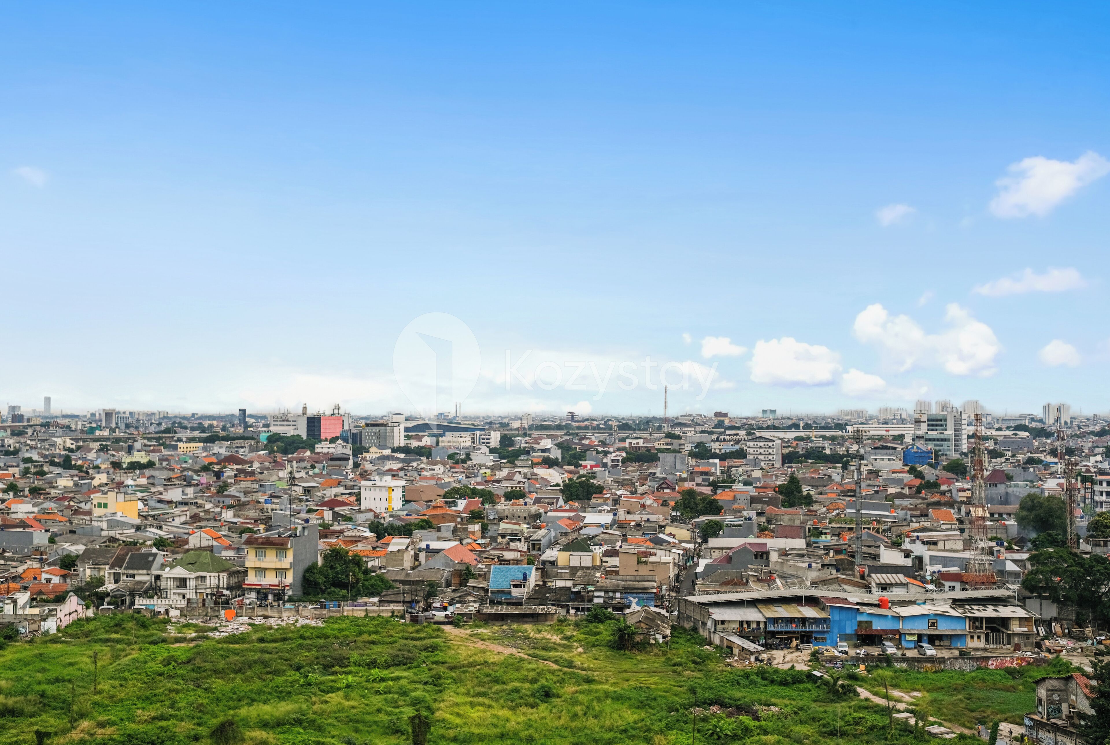 A cityscape with dense urban buildings and a clear sky.