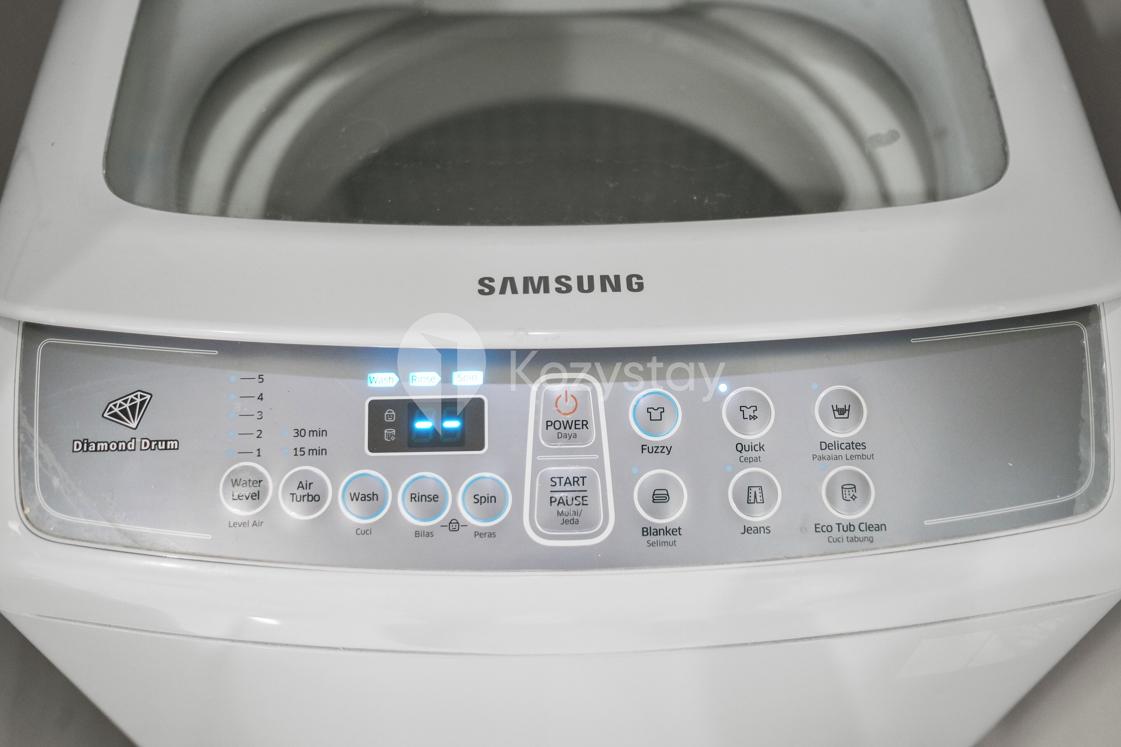 A Samsung washing machine with a control panel featuring various settings and options.