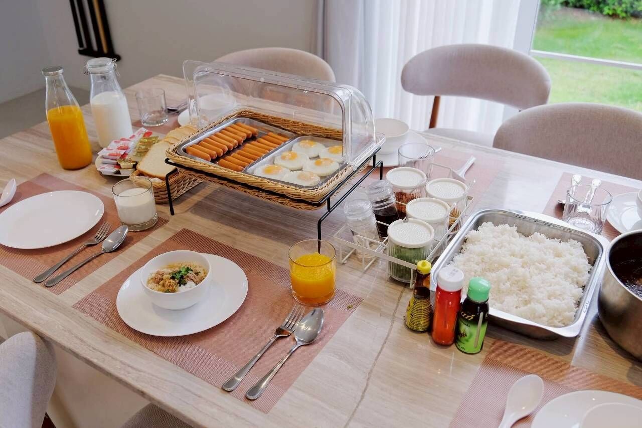 Buffet de café da manhã com diversos alimentos, bebidas e acompanhamentos.
