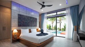 A modern hotel room with a large bed, a ceiling fan, a view of the pool, and a large artwork on the wall.