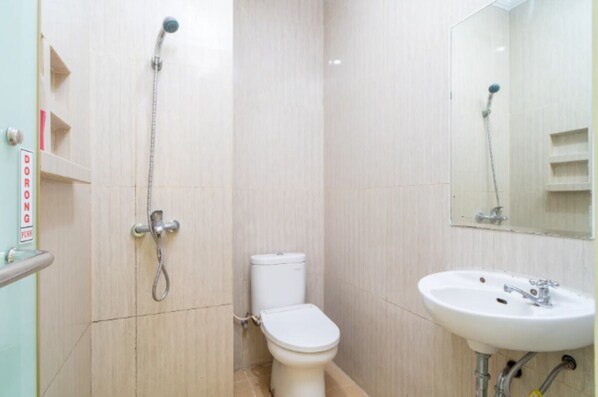 A bathroom with a toilet, a sink, and a shower.