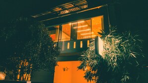 A modern building with large windows and a balcony. - Pine Beach House (Alappuzha)