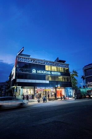 A multi-story building with signage for 'Mughal Suites' and 'Factory Outlet'. - MUGHAL SUITES (Kanayannur)