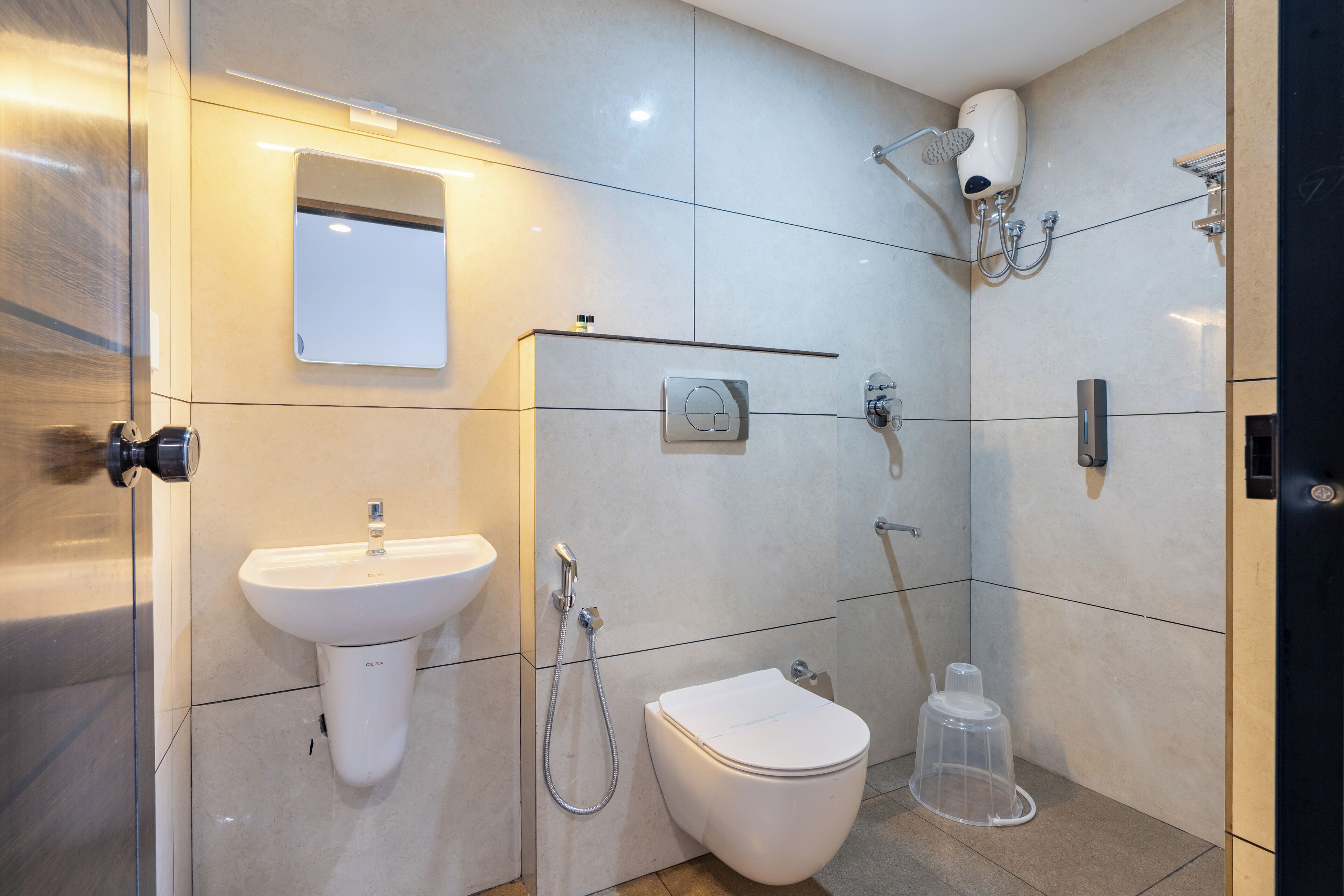 A modern bathroom with a sink, toilet, and shower.