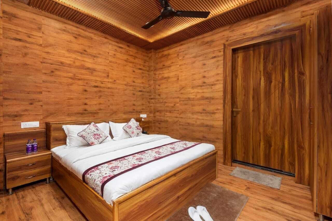 A wooden-paneled bedroom with a bed, nightstands, and a wardrobe.