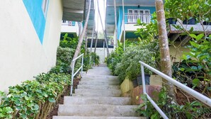 A staircase leading to a building with a balcony. - Aqua Beads Samed (Rayong)