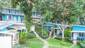 A residential area with multiple two-story houses, a central pathway, and lush greenery. - Aqua Beads Samed (Rayong)