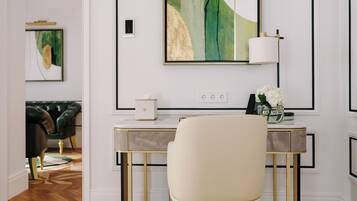 A modern room with a desk, chair, and artwork on the wall.