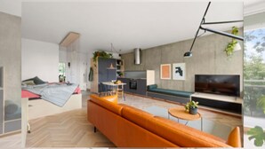 A modern living room with a sofa, a TV, and a dining area. - NYC Studio in Central Oslo (Oslo)