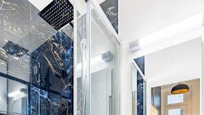 A modern bathroom with a glass-enclosed shower, a white sink, and a dark wooden vanity. - 1#Cosystudio#Paris13#JardinDesPlantes (Paris)