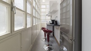 A narrow kitchen with a refrigerator, a sink, and a window. - CS Termini Nazionale Apt n. 4 (Roma)