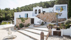 A modern white building with a stone facade, a central staircase, and a statue in the foreground. - My Rental Homes - Villa Rigel with private pool and terraces (San Jose)