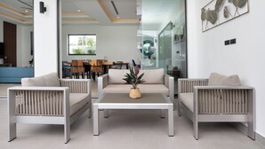 A modern living room with a sofa set, a coffee table, and a decorative plant. - Villa Malaki, pool villa 2 bedrooms at rawai (Tambon Rawai)
