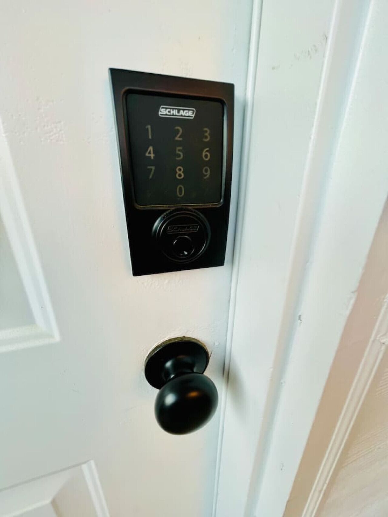 A door with a SCHLAGE electronic keypad lock.