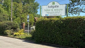 A sign for a tollgate hotel & leisure with a parking area in front. - Tollgate Hotel (Stoke-on-Trent)