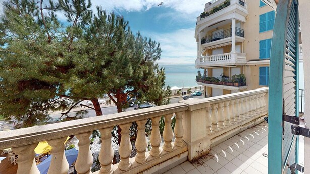 A balcony with a view of the sea, a building with balconies, and a tree. - Spacious 3BR Center Menton with Terrace, Parking, Pool (Menton)