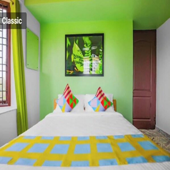 A room with a bed, green walls, a window with curtains, and a door. - Vibrant stay (Chennai)