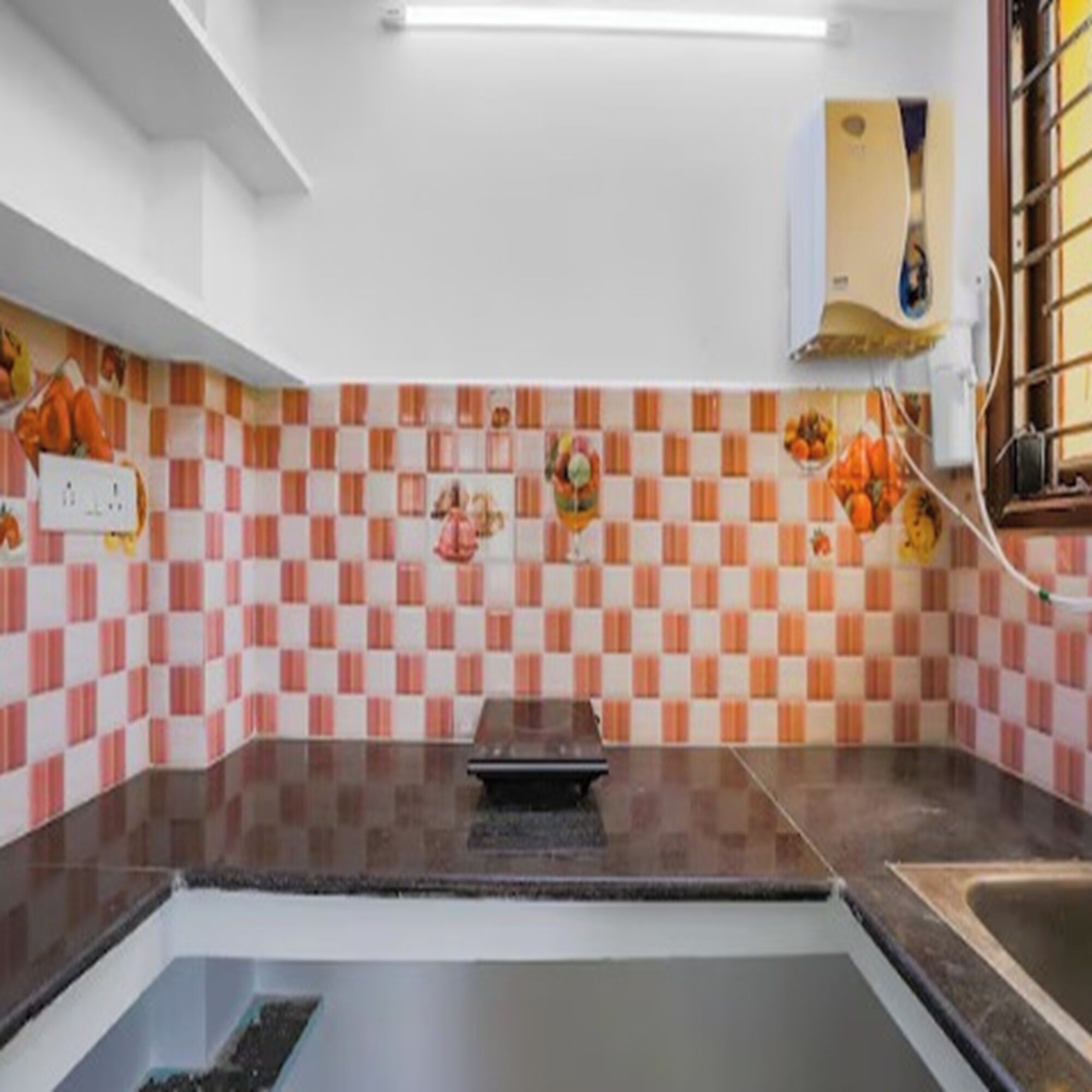 A kitchen with a checkered backsplash, a sink, and a countertop.