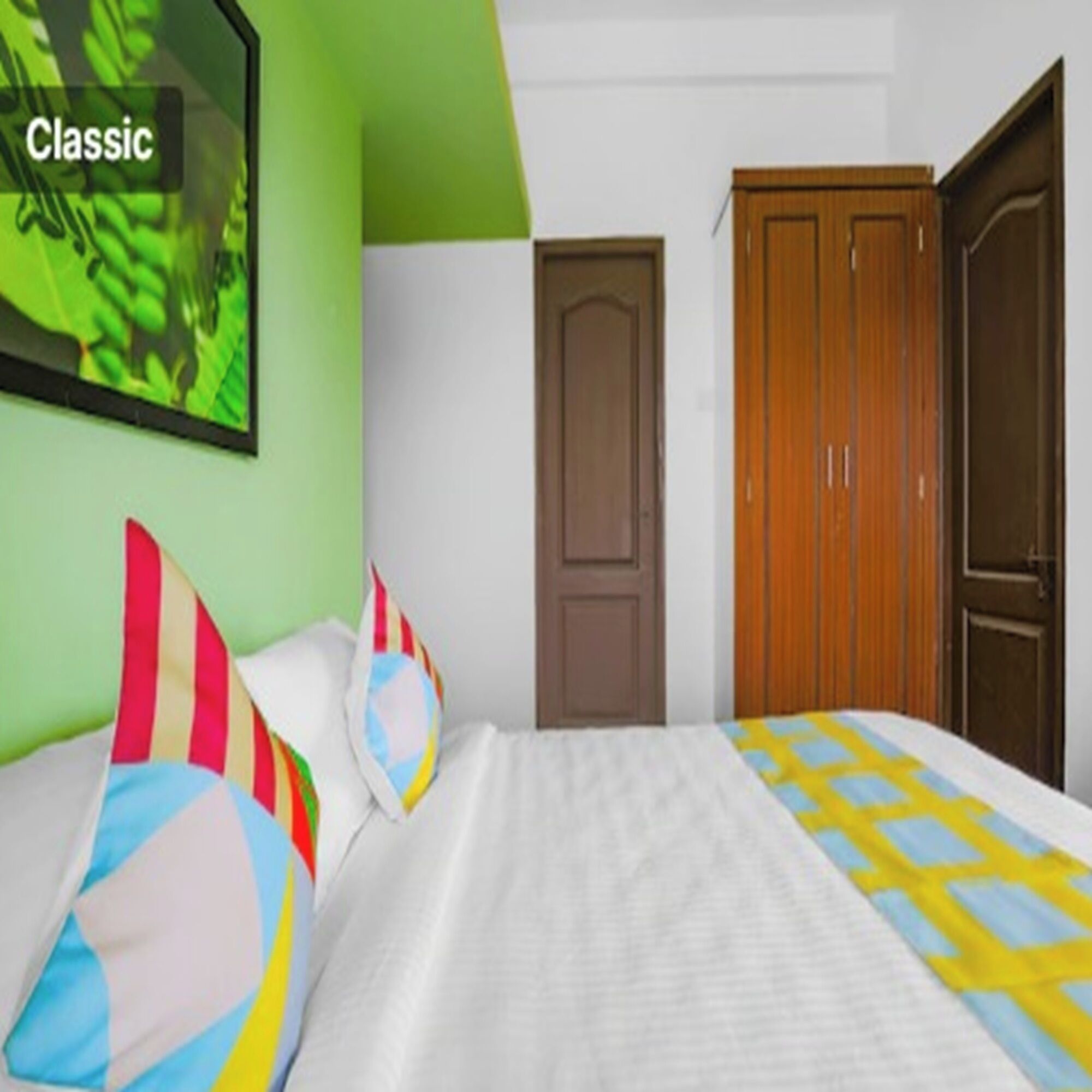 A room with a bed, green walls, and a door.