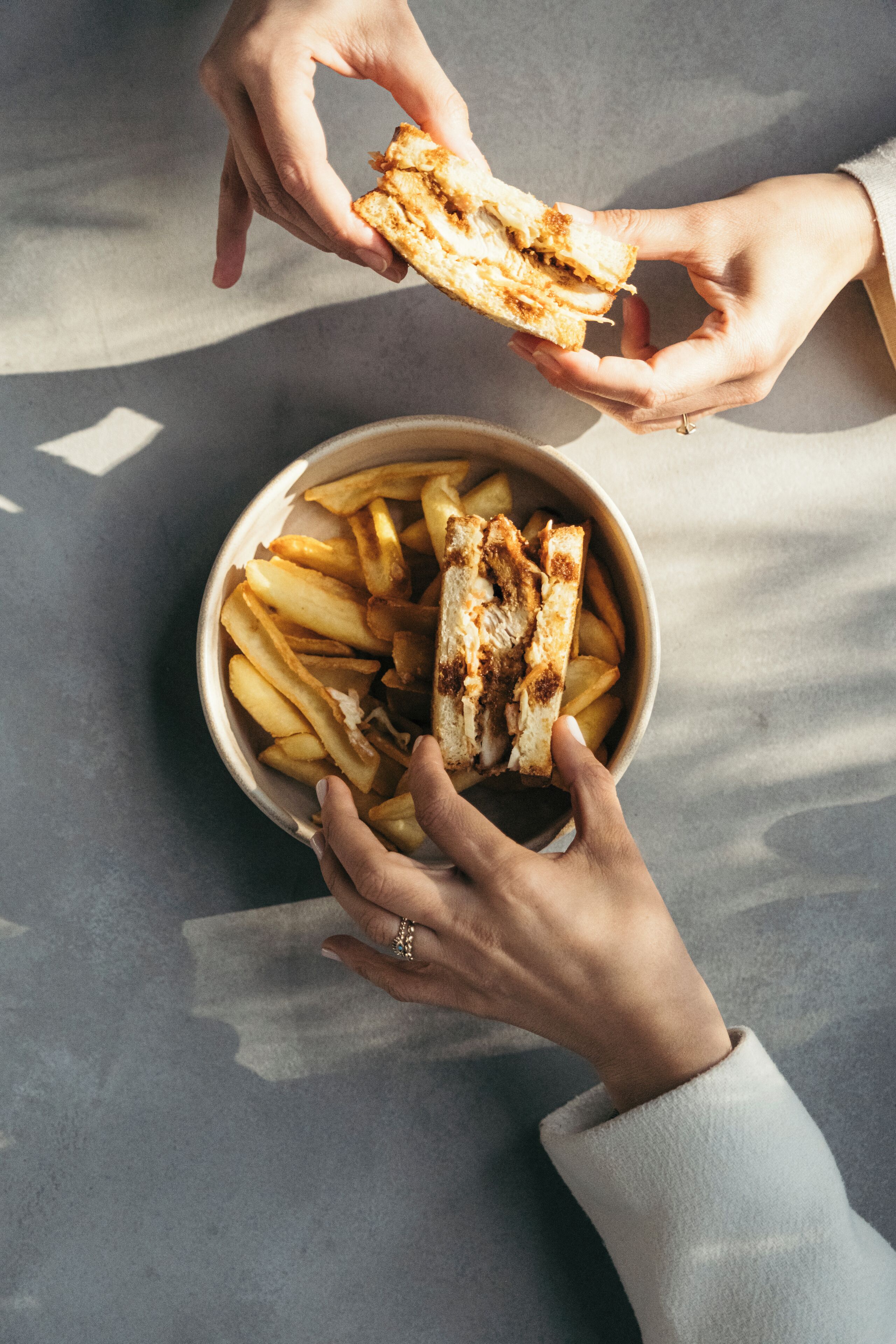 A bowl of fries and grilled cheese sandwich.