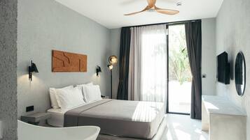 A modern bedroom with a bed, bedside tables, a ceiling fan, and a large window with curtains.