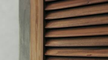 A close-up of wooden blinds with a horizontal slat design.