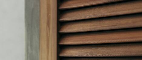 A close-up of wooden blinds with a horizontal slat design.