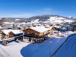 A snow-covered village with wooden buildings, including a prominent house named "Haus Daniela." - Beautiful apartment for 2 people with WIFI, TV and balcony (Wildschönau)