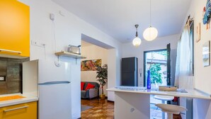 A modern kitchen with a white refrigerator, a built-in oven, and a wooden herringbone floor. - Beautiful apartment for 5 guests with A/C, WIFI and patio (Greve In Chianti)