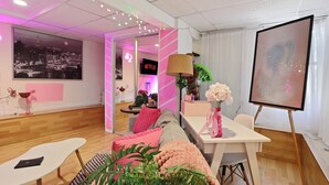 A modern living room with a sofa, coffee table, and a TV screen displaying 'Netflix'. - Barbiecore Dream Pad in Sacramento! (Sacramento)