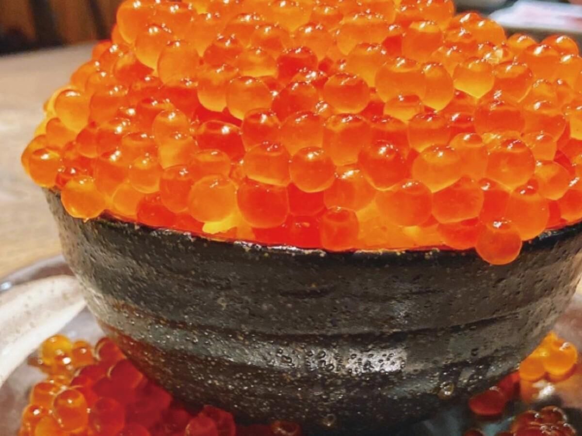 A bowl filled with orange fish roe.