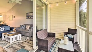 A cozy living room with a sofa, armchairs, and a coffee table. - Good Vibes on the Green | Bright, Airy 2BR River Oaks Stay (Myrtle Beach)