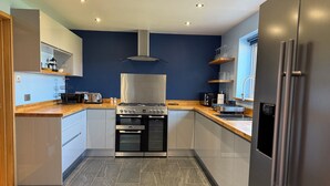 A modern kitchen with a gas stove, oven, and stainless steel appliances.