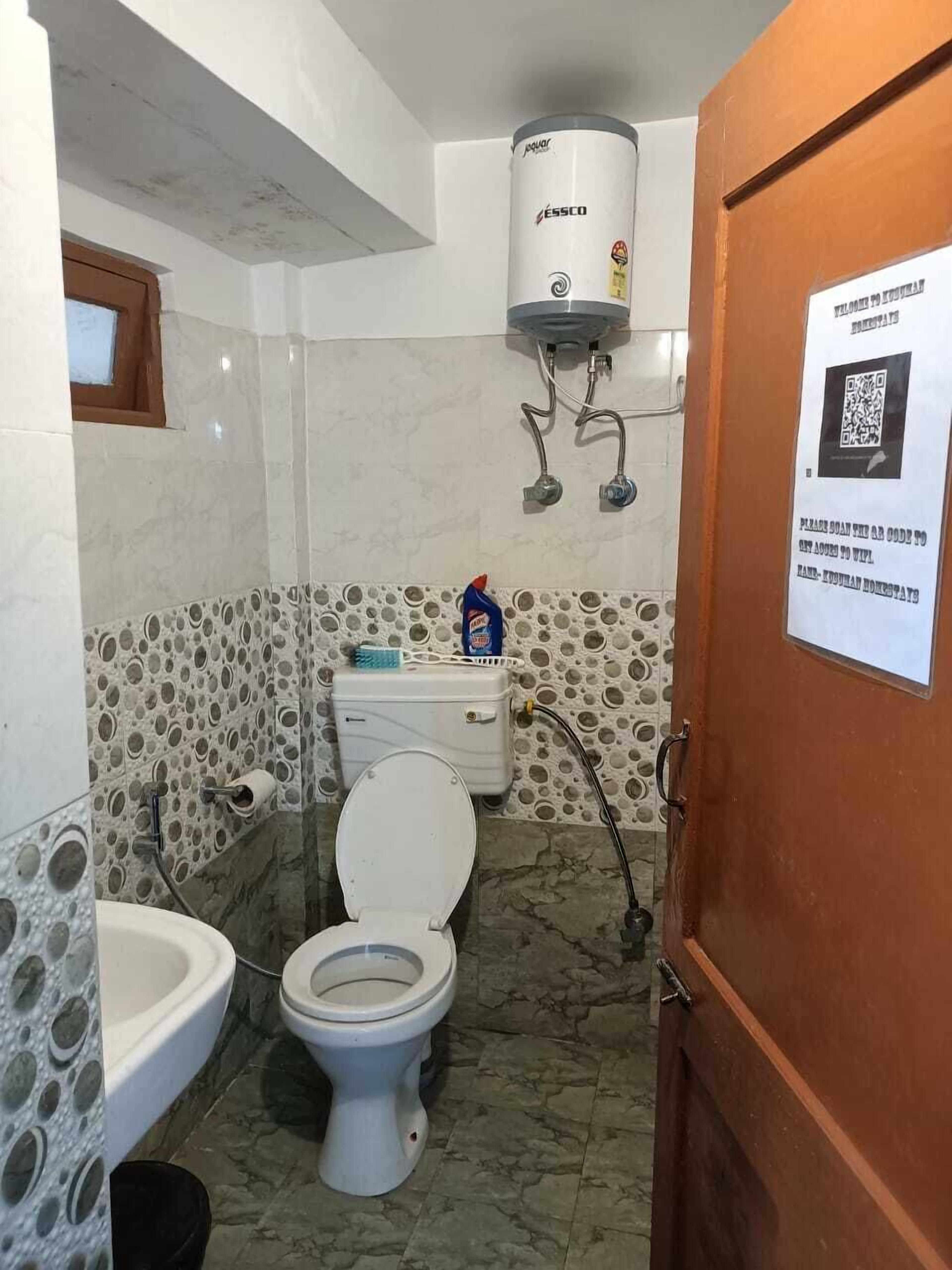 A bathroom with a toilet, bidet, and a water heater.