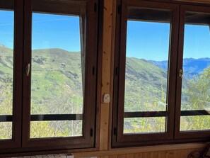 Enjoy breathtaking views of the surrounding mountains from this room's window.
