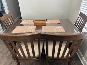 Enjoy meals in this cozy dining area with a round table and comfortable seating for four.