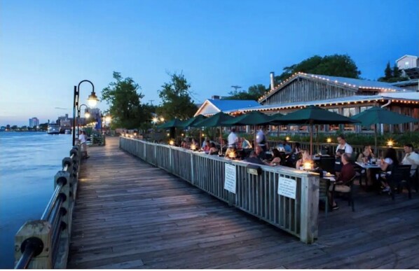 Enjoy a meal with a view at this waterfront restaurant, where tables are set under umbrellas on a wooden deck overlooking the water.