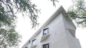 A multi-story building with a flat roof and a covered entrance area. - Hotel Indra Palace (Udaipur)