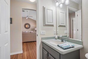 A bathroom with a vanity, mirror, and a ceiling fan. - Stunning sunsets, wildlife views & golf cart included for Villages lifestyle  (The Villages)