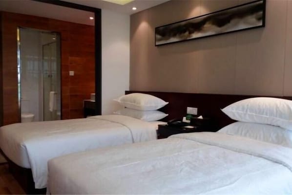 A hotel room with two beds, a wooden wall, a painting, and a bathroom visible through a glass door. - Baolong Yugang Hotel (Shanghai)